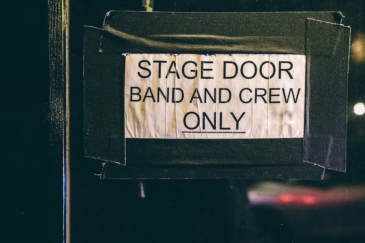 A sign on a stage door reading: band and crew only.